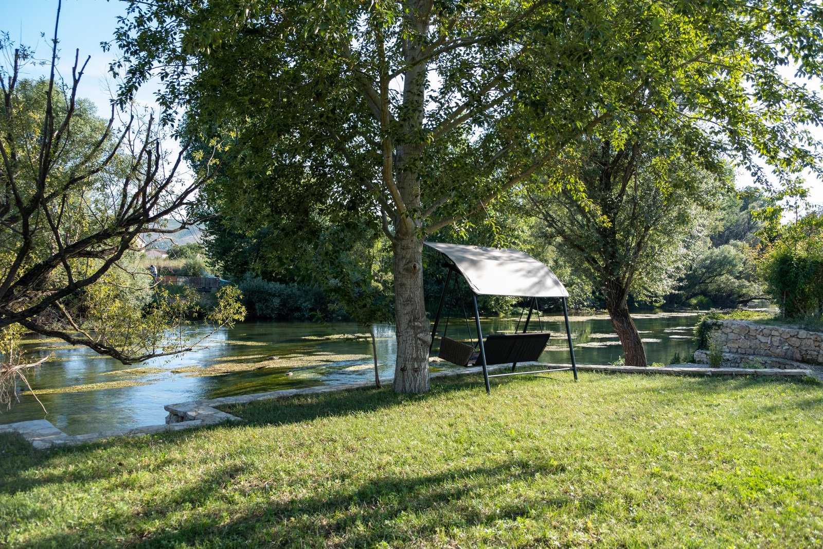 Garden swing on the banks of the Buna river at Villa Verona in Blagaj